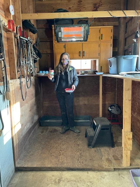 Liz from Cats in Action in a barn where she takes care of feral cats